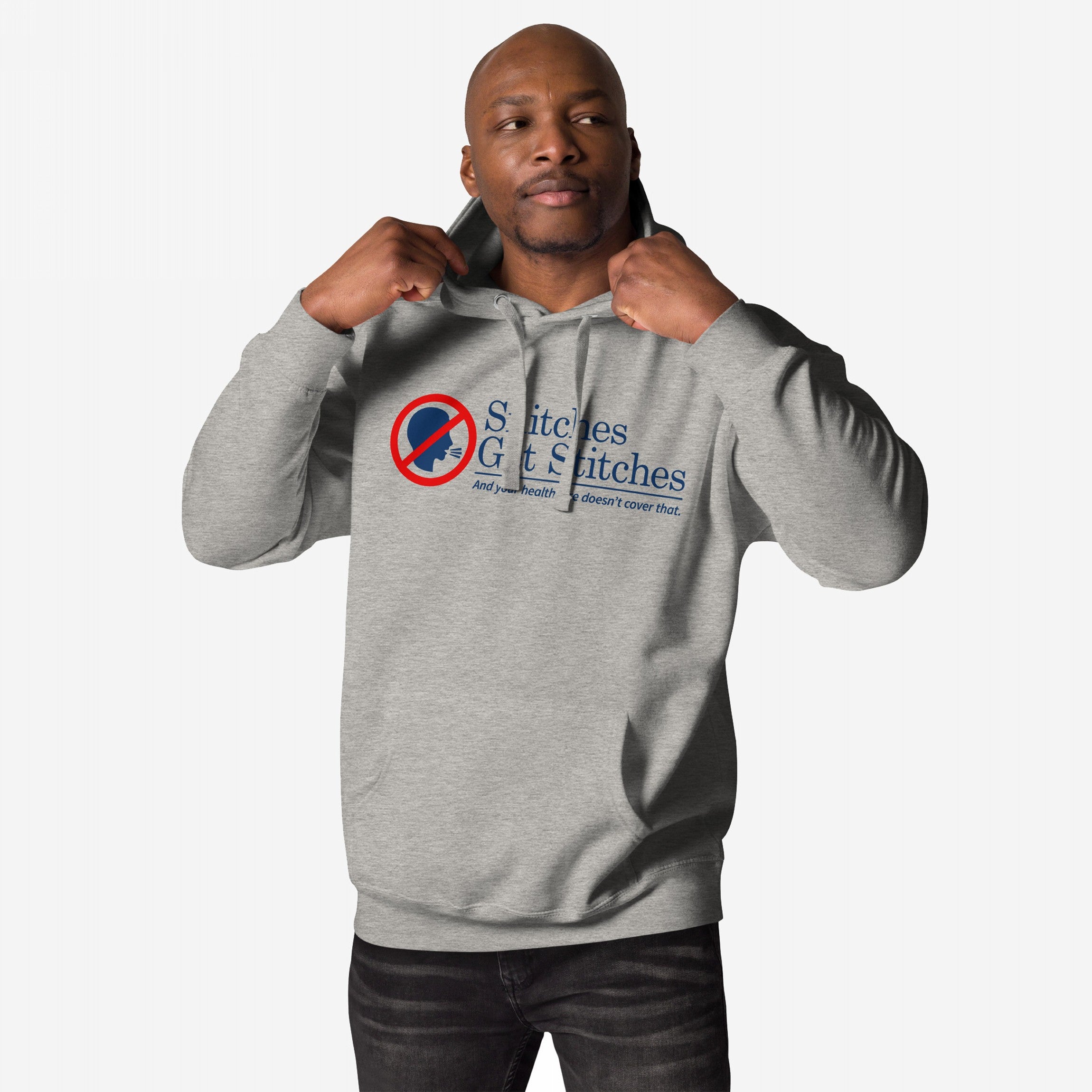 Man wearing Snitches Get Stitches Hoodie with bold slogan critiquing snitches and healthcare. The graphic features a silhouette with a red no symbol. Ideal for those with a sharp, dark sense of humor.