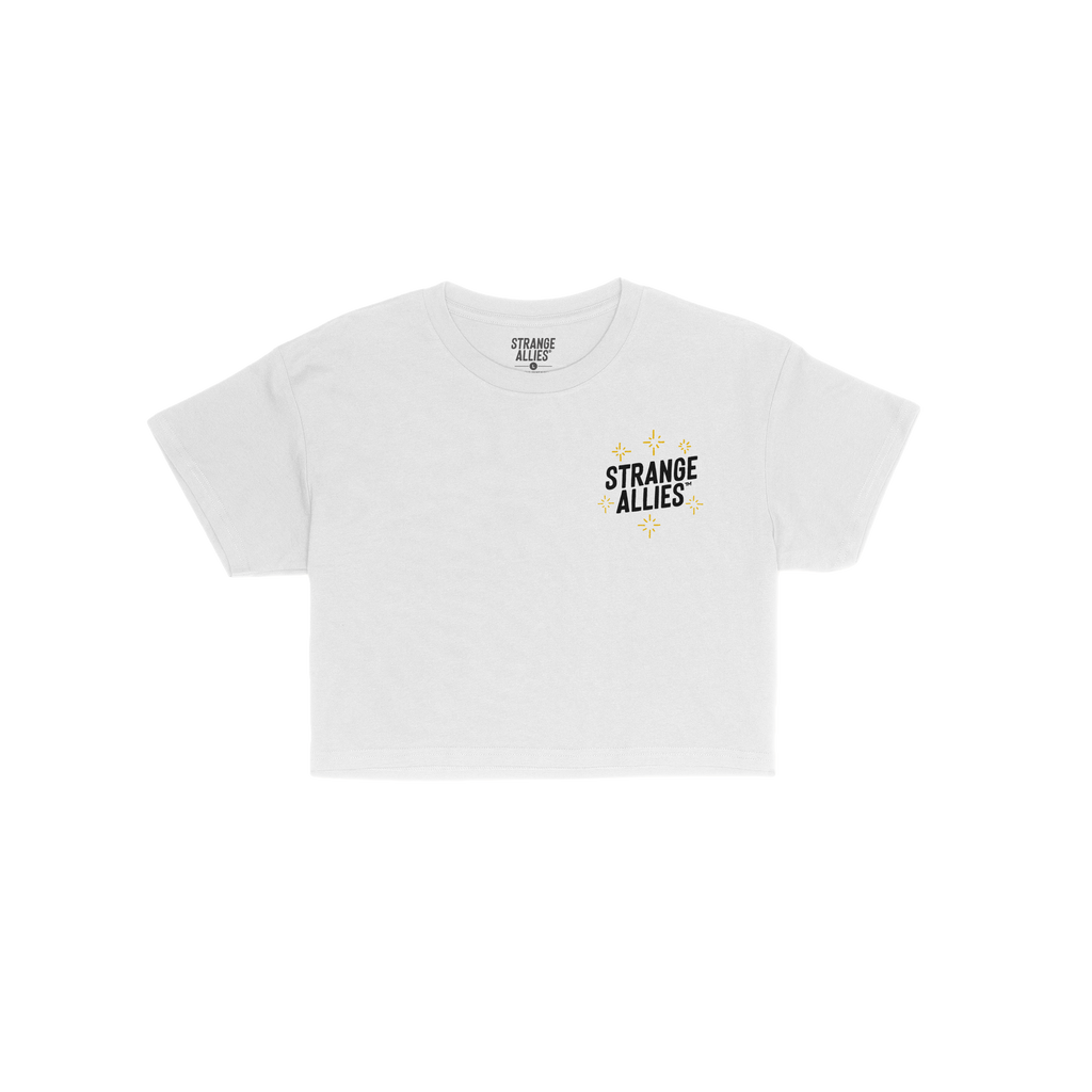 Social Club Women's Baby Tee featuring a small STRANGE ALLIES logo with gold starburst graphics on the chest, laid flat on a 