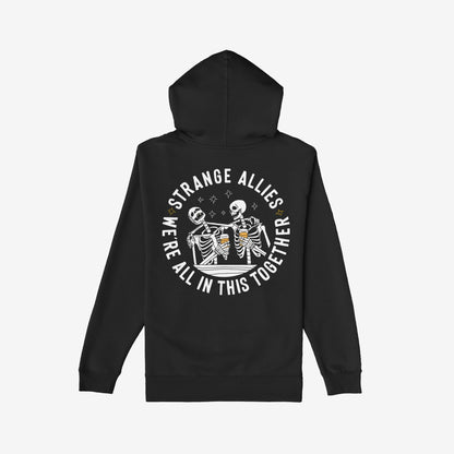 Social Club Hoodie & Sweatshirt features a back design with skeletons clinking beer mugs, surrounded by the text “STRANGE ALLIES” and “WE’RE ALL IN THIS TOGETHER,” embodying solidarity and humor.