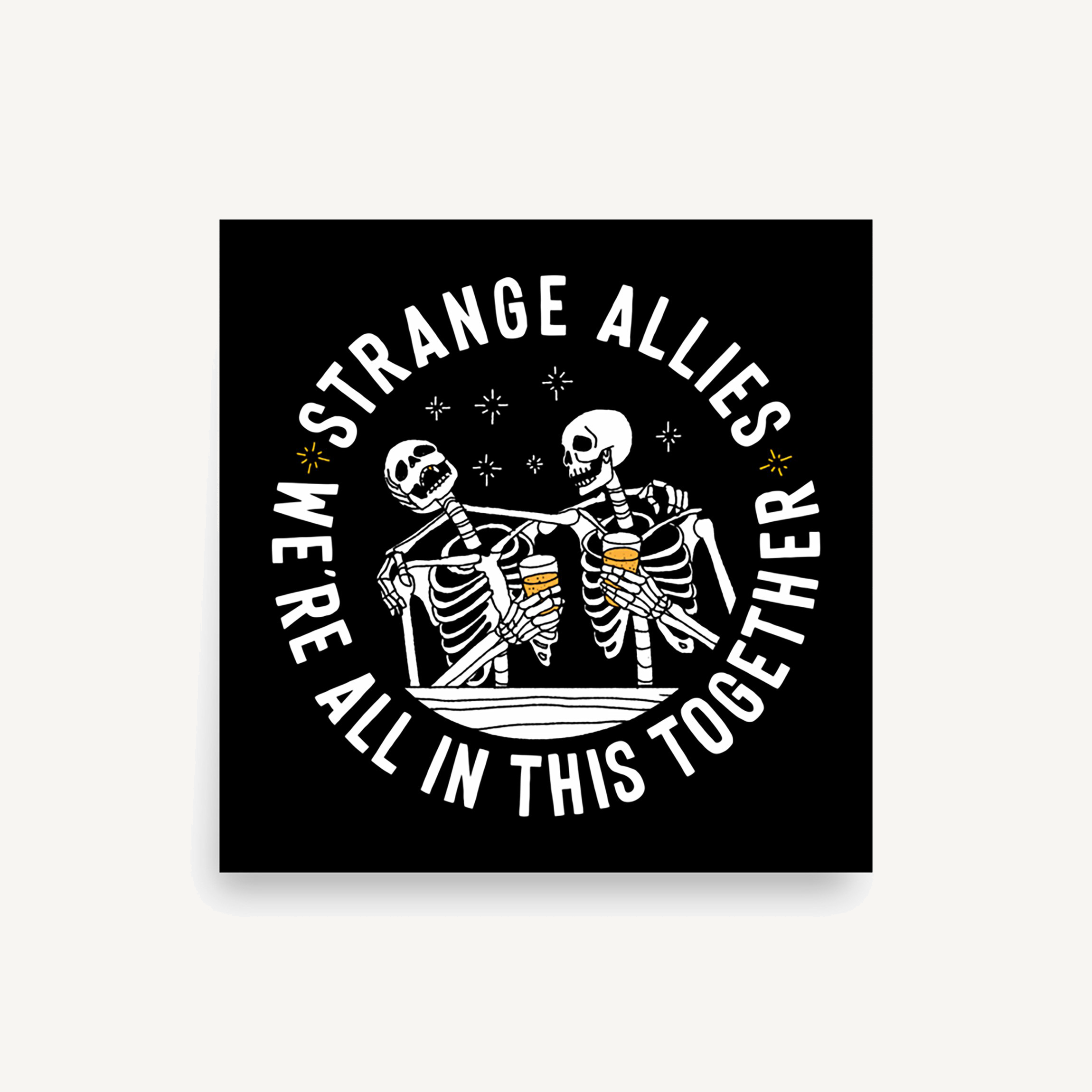 Social Club Giclée Print features two skeletons cheering with beer mugs, surrounded by the phrases STRANGE ALLIES and WE’RE ALL IN THIS TOGETHER, embodying unity and inclusivity.