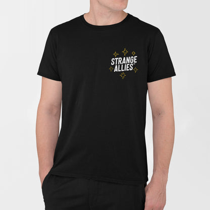 Social Club T-shirt featuring STRANGE ALLIES text on the chest with yellow starbursts; model's hands at sides, epitomizing camaraderie and inclusion.