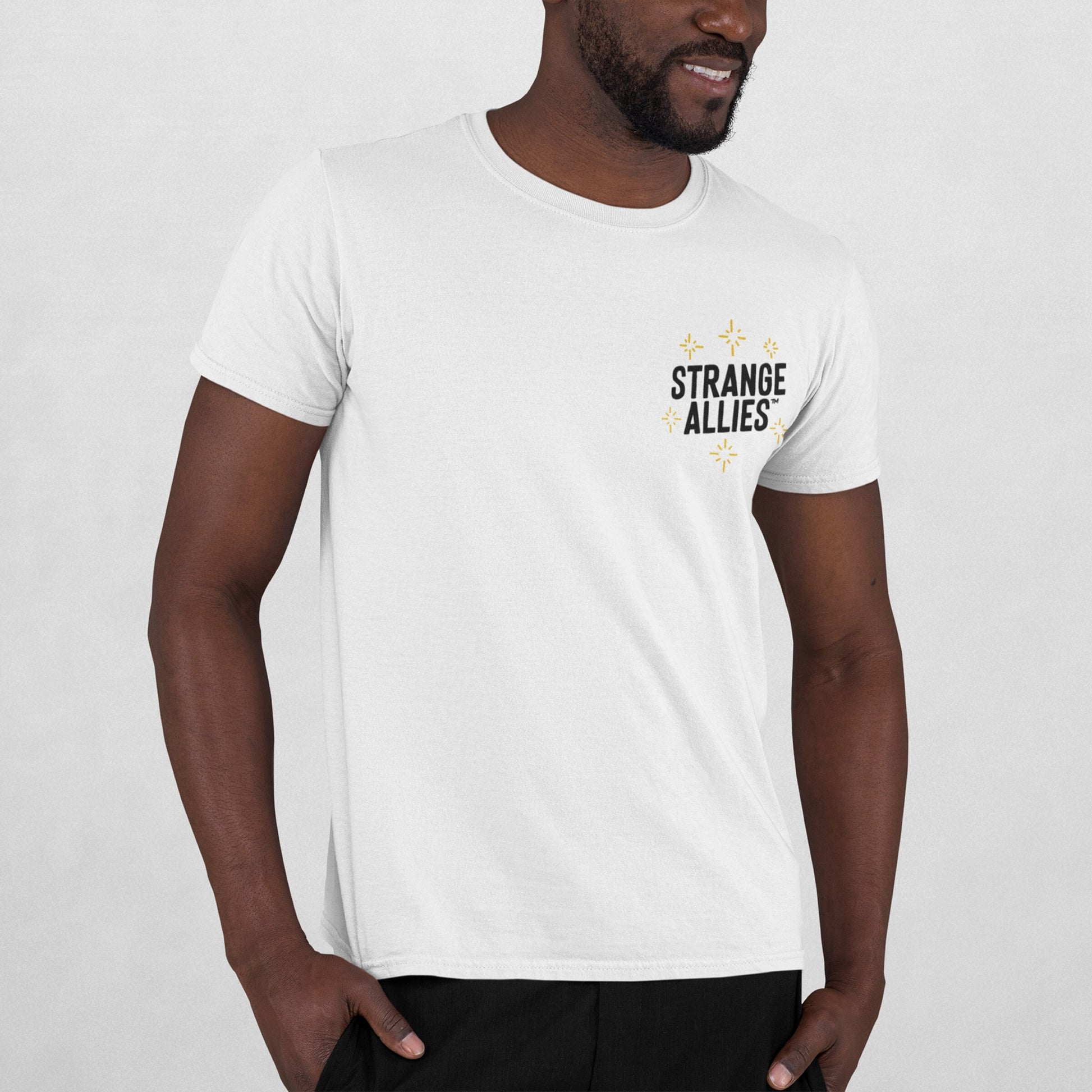 Social Club T-shirt on Black male model, featuring a small STRANGE ALLIES™ graphic with starbursts on front and skeletons clinking glasses on back, embodying unexpected connections and shared truths.