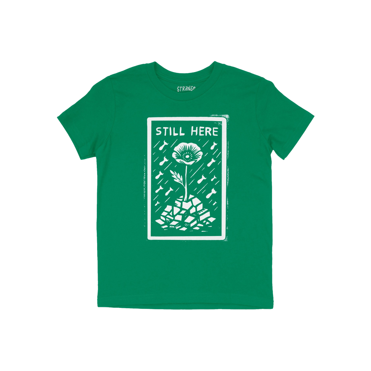 Still Here T-shirt features a white graphic of a flower emerging from rubble amid falling bombs, symbolizing resilience and p