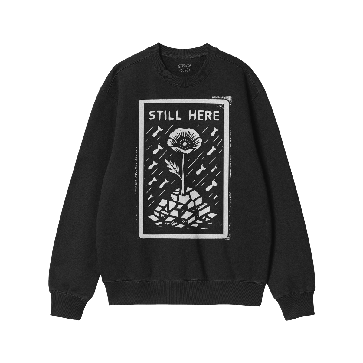 Still Here JULZ Hoodie & Sweatshirt displays a flower emerging from rubble amid falling raindrops, symbolizing resilience and