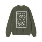 Still Here JULZ Hoodie & Sweatshirt features a linocut-style flower growing through rubble under raindrops with STILL HERE te