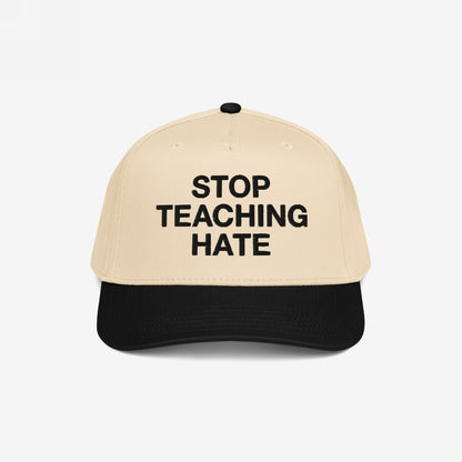 Two-tone baseball cap with a beige crown and black bill, featuring “STOP TEACHING HATE” in bold black letters, symbolizing a commitment to equality and a stance against bigotry.