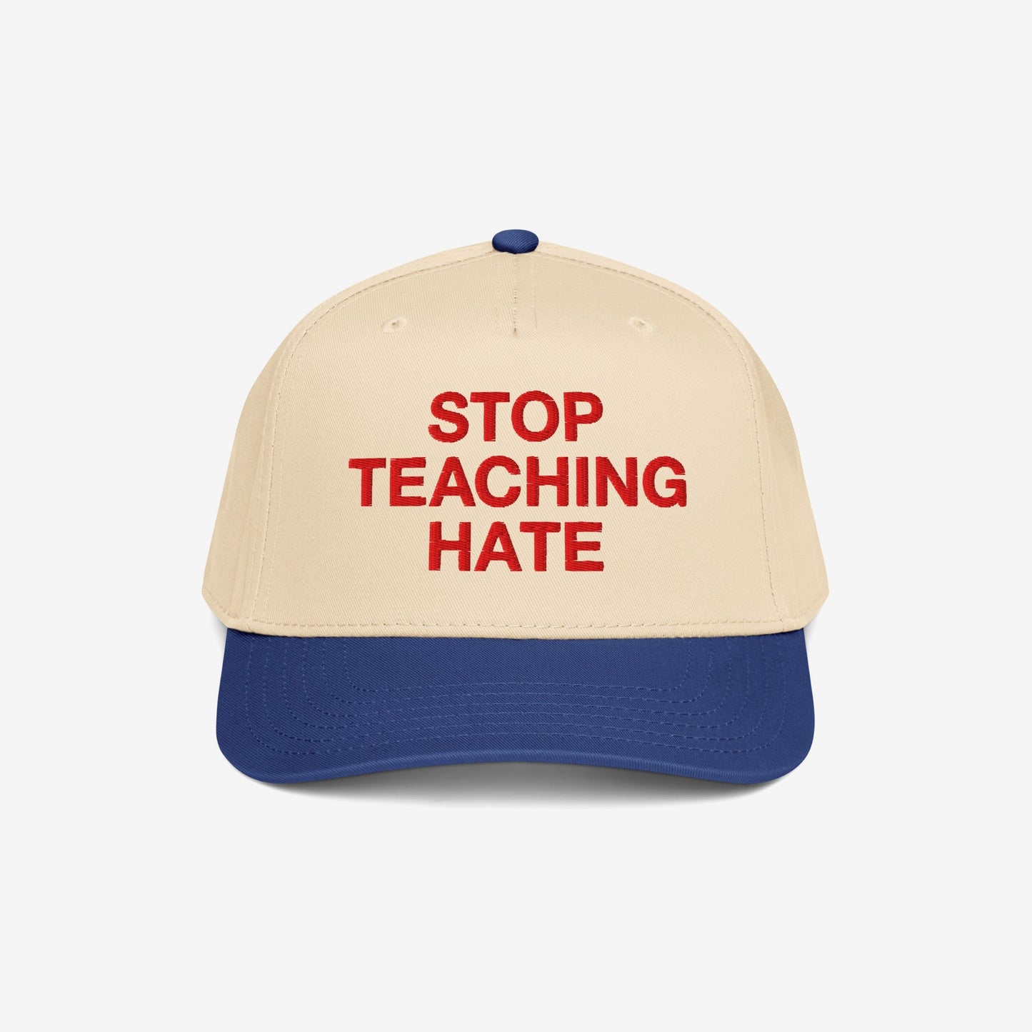 Stop Teaching Hate Hat with bold red embroidery on a two-tone baseball cap, symbolizing a strong stance against intolerance and promoting equality through impactful design.