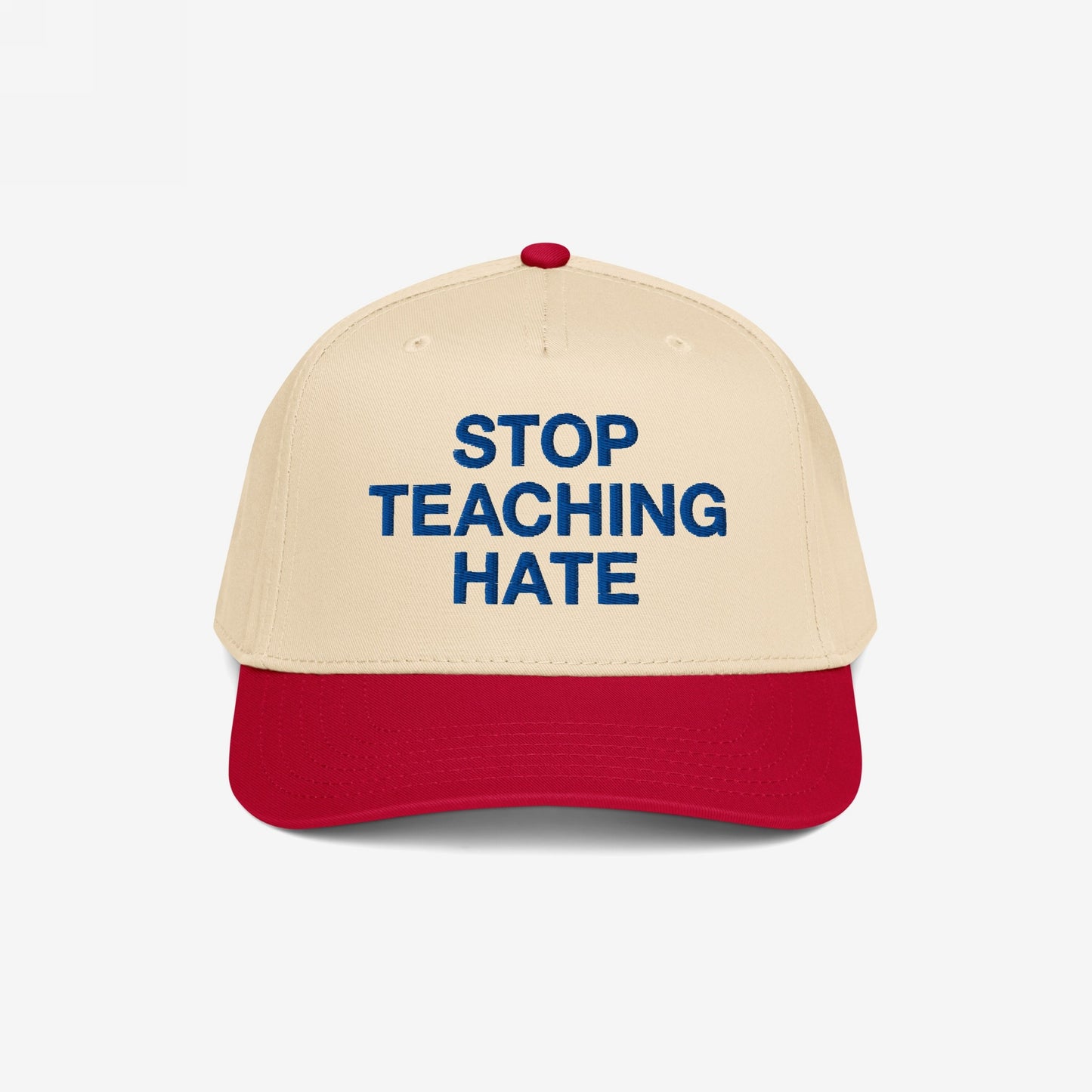 Stop Teaching Hate Hat with bold blue embroidery on a beige and red baseball cap, embodying a strong stance against bigotry, promoting equality and respect through its powerful message.