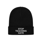 Black rib-knit beanie with STOP TEACHING HATE embroidered in white on the cuff, embodying a bold stance against hate.
