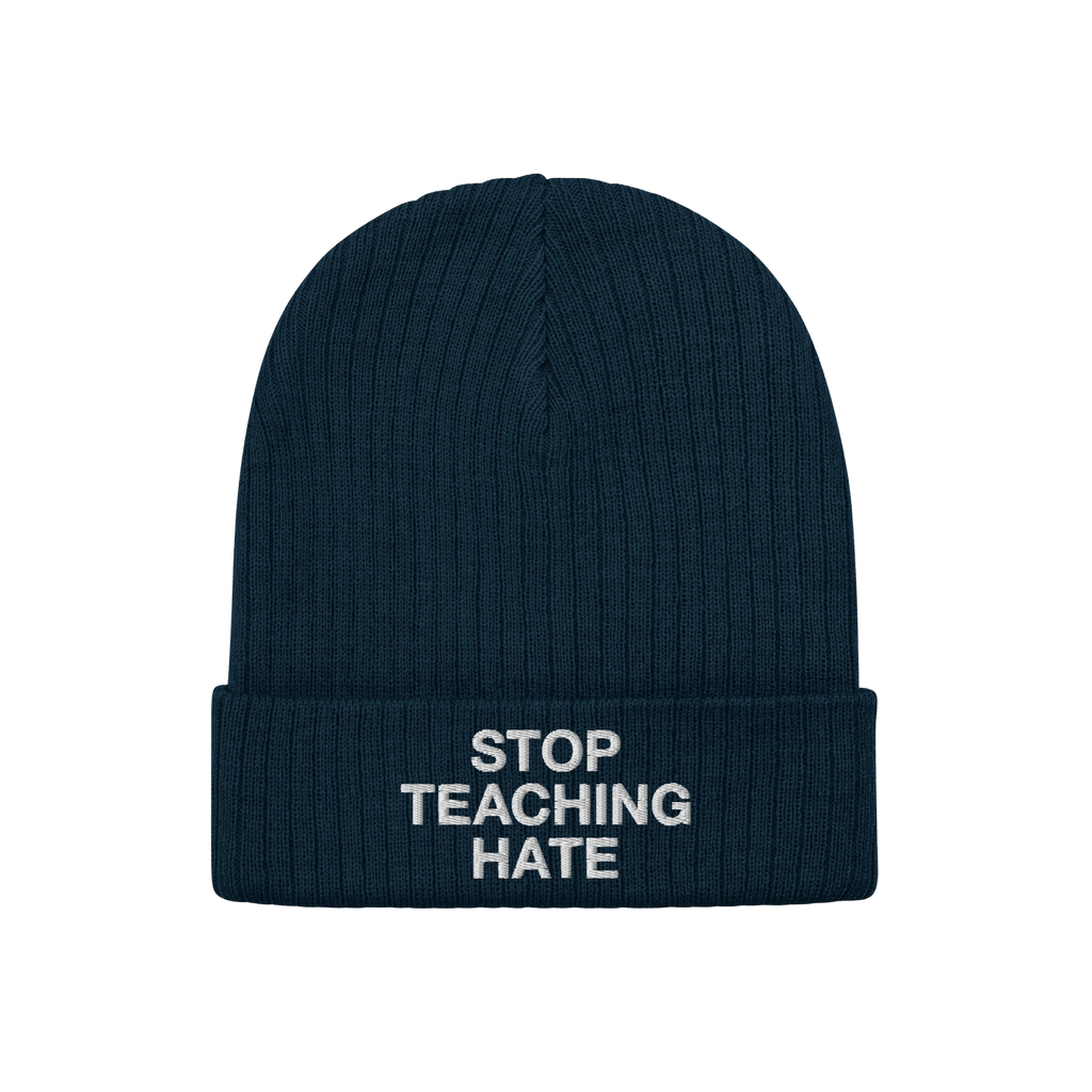 Dark navy-blue, rib-knit winter beanie with folded cuff featuring the bold slogan STOP TEACHING HATE in white lettering, embo