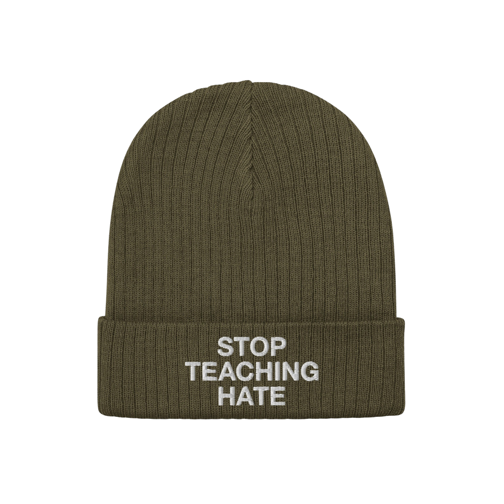 Olive-green knit beanie with a folded cuff featuring the bold statement STOP TEACHING HATE embroidered in white, embodying a 