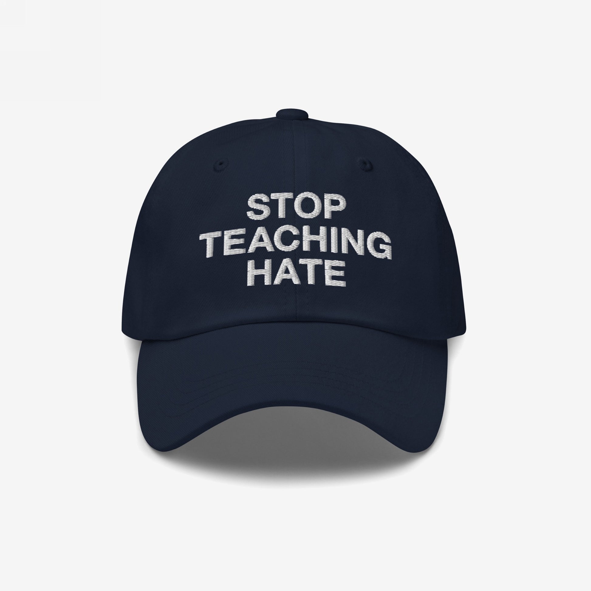 Dark navy baseball-style cap featuring STOP TEACHING HATE in white embroidery. The Stop Teaching Hate Hat embodies a bold statement against learned hate, perfect for expressing your values subtly yet powerfully.