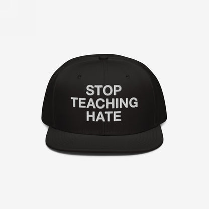 Black flat-brim snapback hat featuring the bold slogan “STOP TEACHING HATE” embroidered in white, embodying a visual protest message for equality and justice.