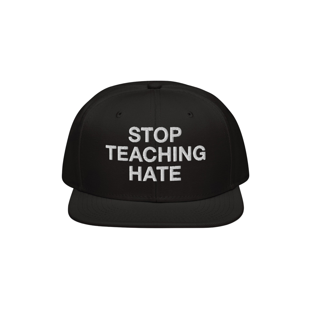 Black flat-brim snapback hat featuring the bold slogan “STOP TEACHING HATE” embroidered in white, embodying a visual prot