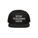 Black flat-brim snapback hat featuring the bold slogan “STOP TEACHING HATE” embroidered in white, embodying a visual prot