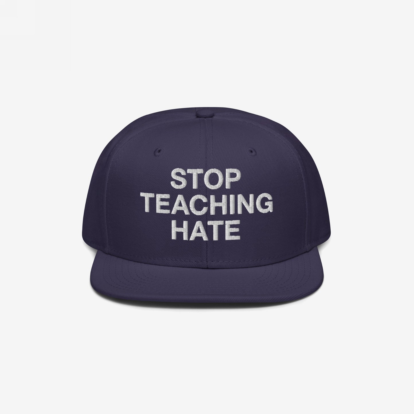 Dark navy-blue, flat-brimmed Stop Teaching Hate Hat with bold white embroidery, embodying a strong anti-hate message, perfect for advocating equality and challenging intolerance in any setting.
