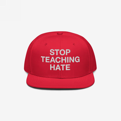 Red snap-back cap with STOP TEACHING HATE embroidered in white, embodying a bold stance against hate; designed for visibility and impact, ideal for expressing convictions in diverse settings.