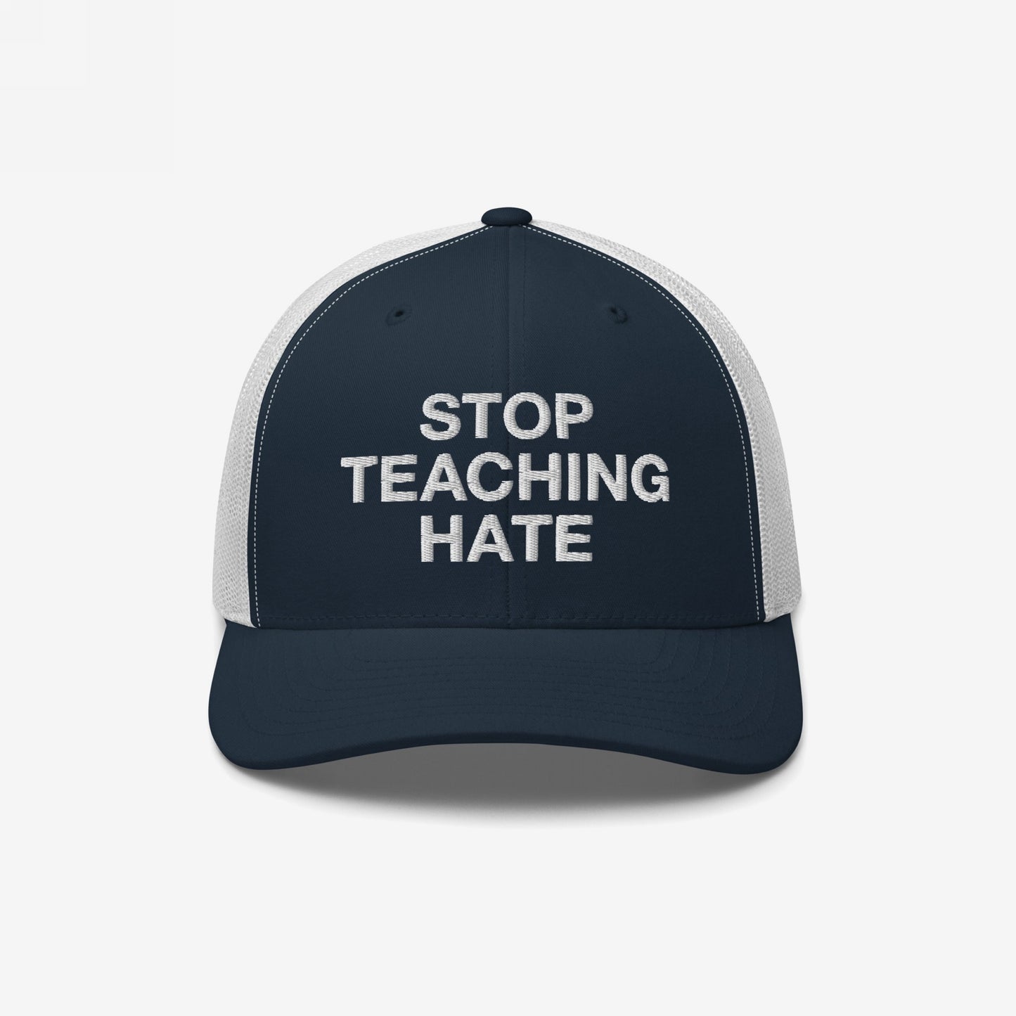 Trucker-style baseball cap featuring STOP TEACHING HATE slogan in bold letters on the front, symbolizing protest against intolerance, with a navy front and white mesh back, reflecting strong values.
