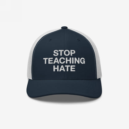 Trucker-style baseball cap featuring STOP TEACHING HATE slogan in bold letters on the front, symbolizing protest against intolerance, with a navy front and white mesh back, reflecting strong values.