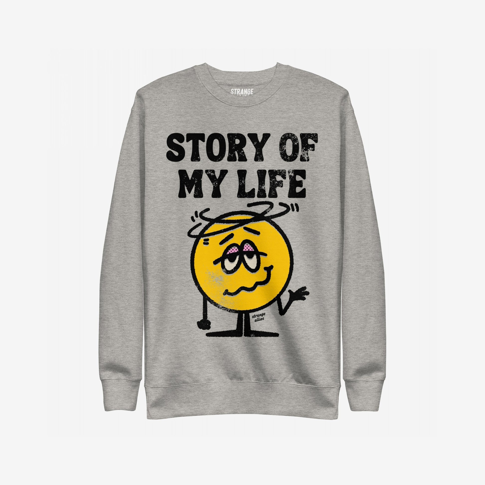 Story Of My Life Sweatshirt featuring a dazed cartoon smiley with droopy eyelids and shrugging arms under bold text, capturing a humorous take on life's mishaps.