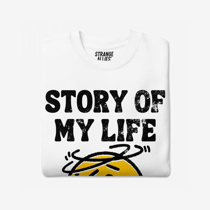 Story Of My Life Sweatshirt features a bold distressed print with a dizzy cartoon face, capturing a relatable theme of life's unpredictability and resilience in style.