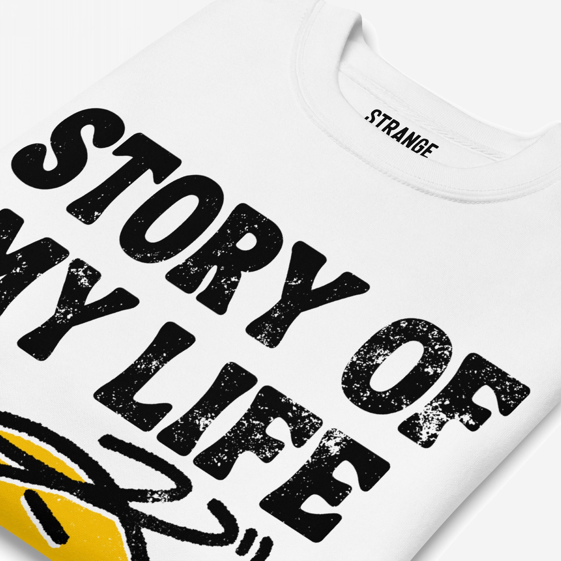 Story Of My Life Sweatshirt features distressed black text with a loose yellow graphic, embodying a humorous take on daily mishaps. Perfect for those embracing life's chaotic moments.