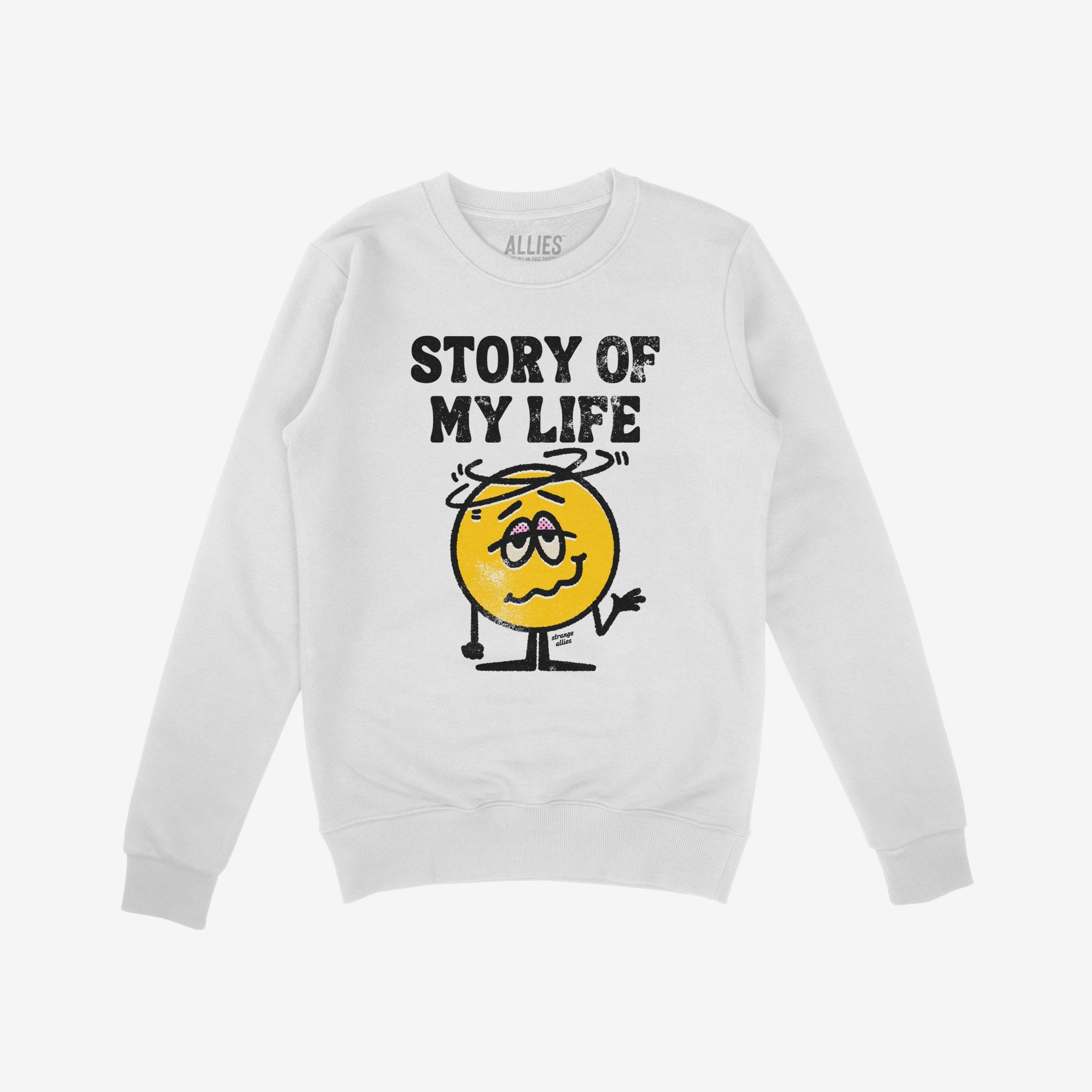 Story Of My Life Shirt features a worn block-letter design and a cartoonish, shrugging, dizzy yellow face, embodying life's chaotic mishaps with relatable humor.
