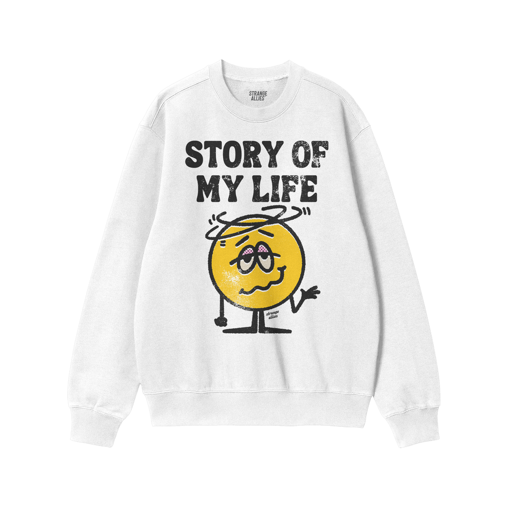 Story Of My Life Shirt features a worn block-letter design and a cartoonish, shrugging, dizzy yellow face, embodying life's c