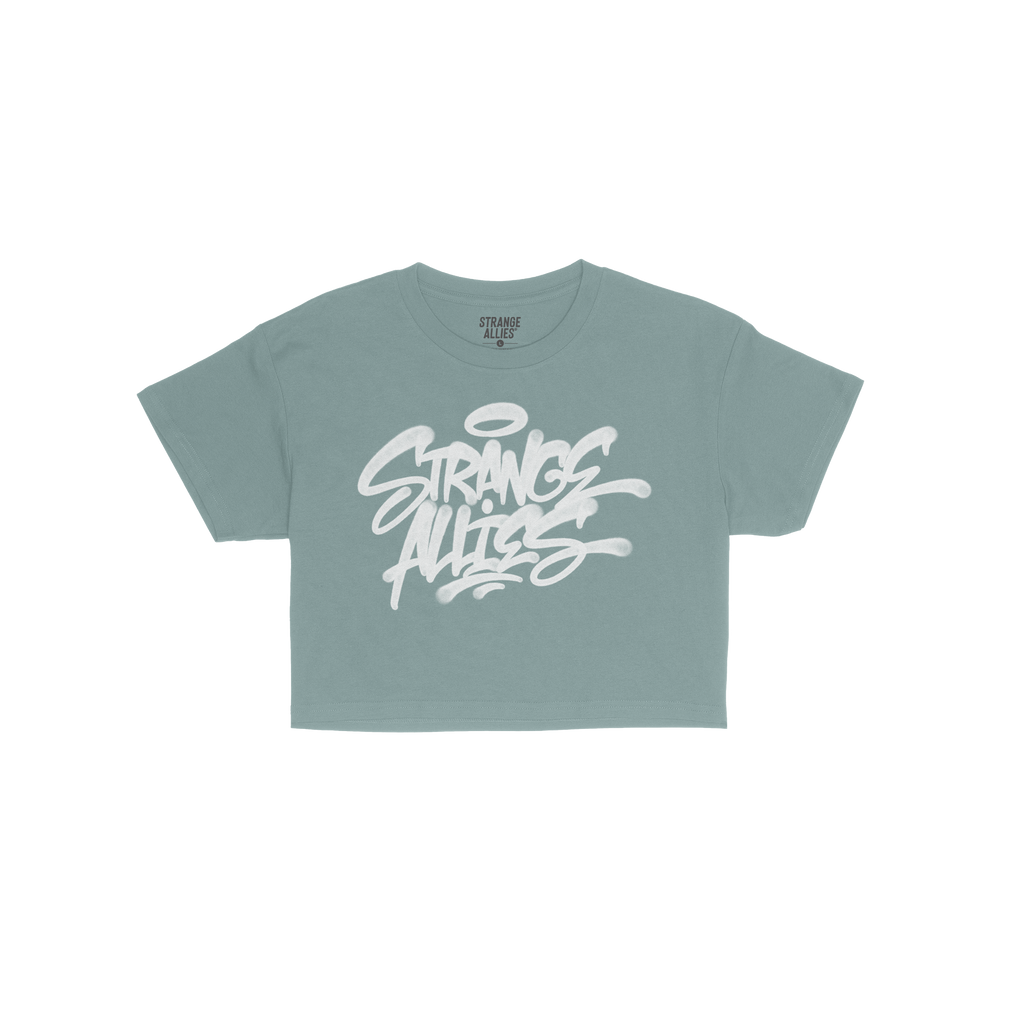 Strange Allies Handstyle Women's Baby Tee features a graffiti-style logo on a blue cropped tee, embodying active allyship and