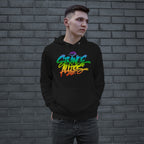 Young man wearing the Strange Allies Rainbow Handstyle Hoodie, featuring vibrant graffiti-style lettering. He stands against a dark grey brick wall, embodying an urban streetwear vibe with hands in the front pouch pocket.