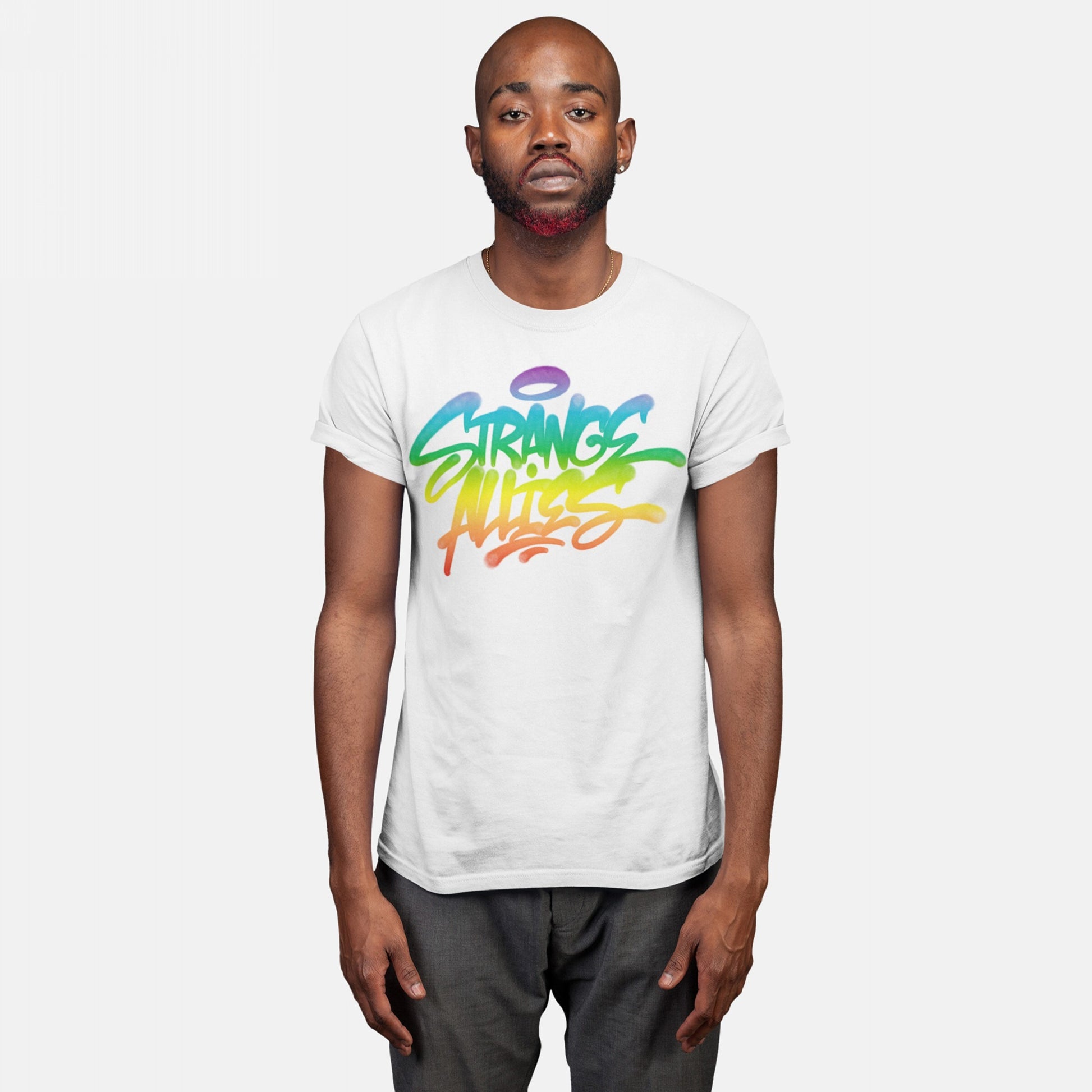 Person wearing the Strange Allies Rainbow Handstyle T-shirt, featuring a graffiti-style design with the words STRANGE ALLIES in vibrant rainbow gradients, symbolizing inclusivity and individuality.