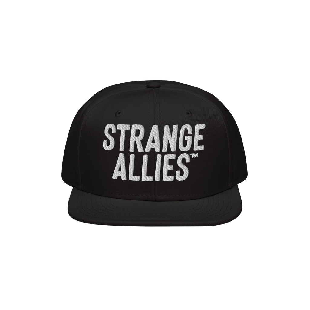 Black flat-brim snapback hat with STRANGE ALLIES™ in bold white embroidery, symbolizing unity and diversity. Part of the St