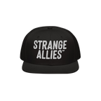 Black flat-brim snapback hat with STRANGE ALLIES™ in bold white embroidery, symbolizing unity and diversity. Part of the St