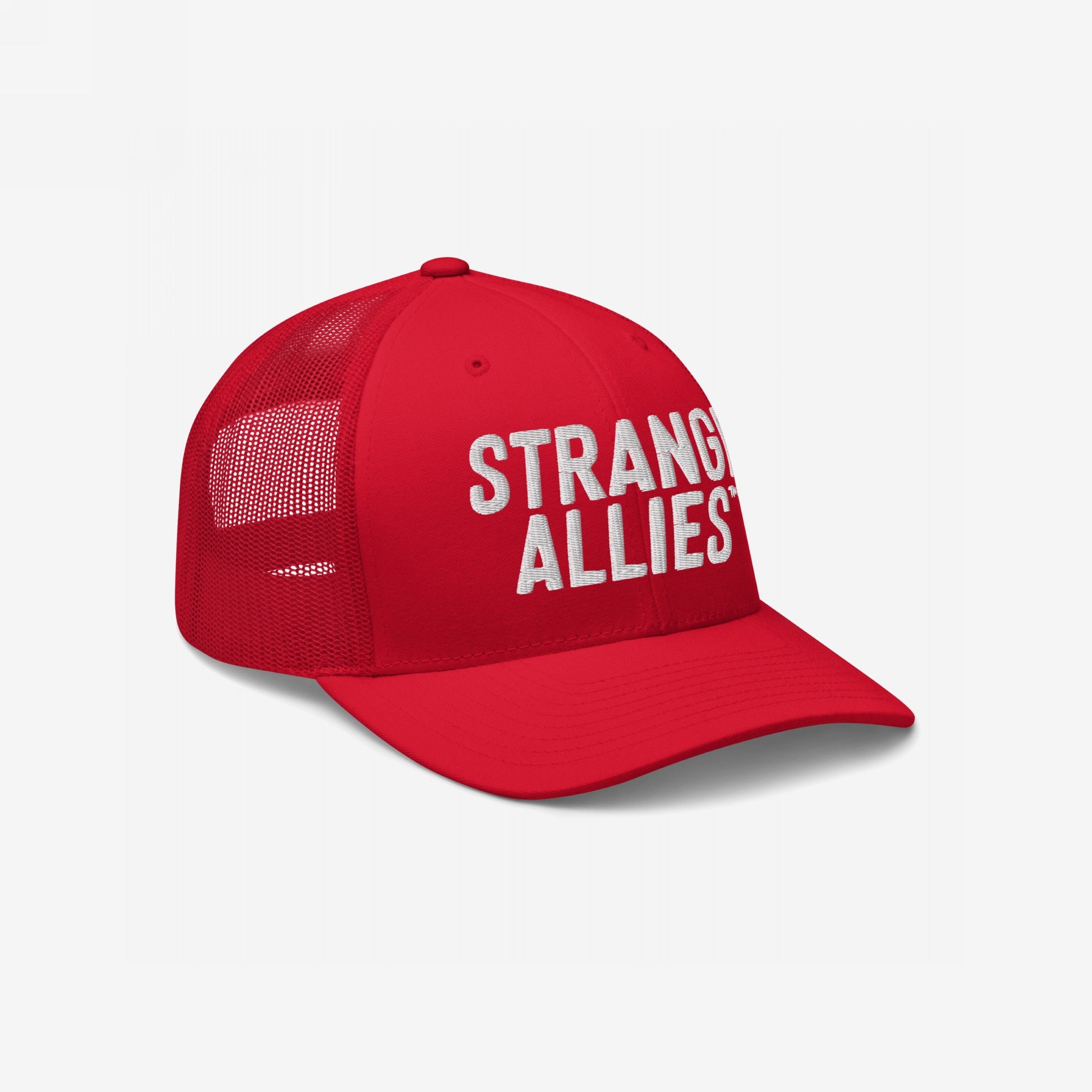 Red trucker-style baseball cap with mesh back, featuring bold white STRANGE ALLIES™ text on the front panel, symbolizing unity in diversity. Ideal for expressing solidarity and embracing individuality.