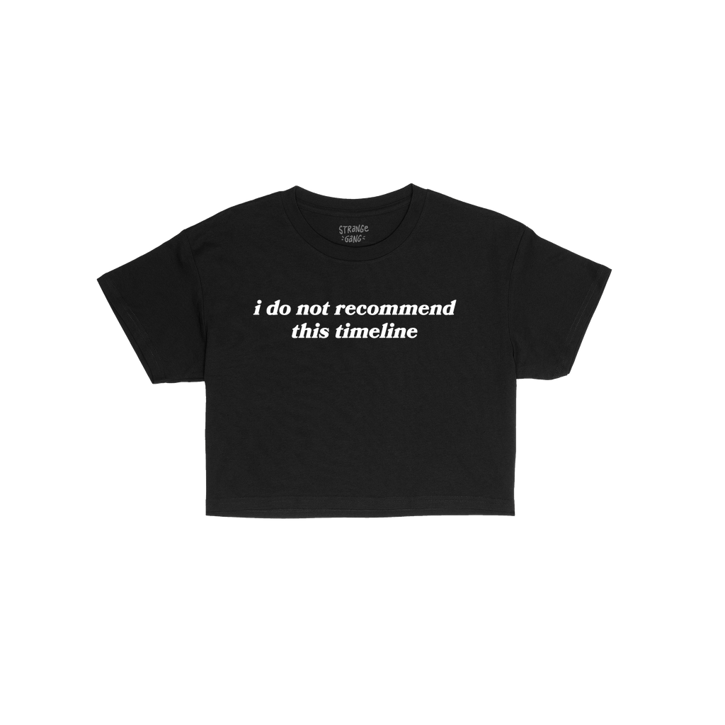 Timeline Women's Baby Tee featuring bold white text, i do not recommend this timeline, on a black, short-sleeved, cropped des