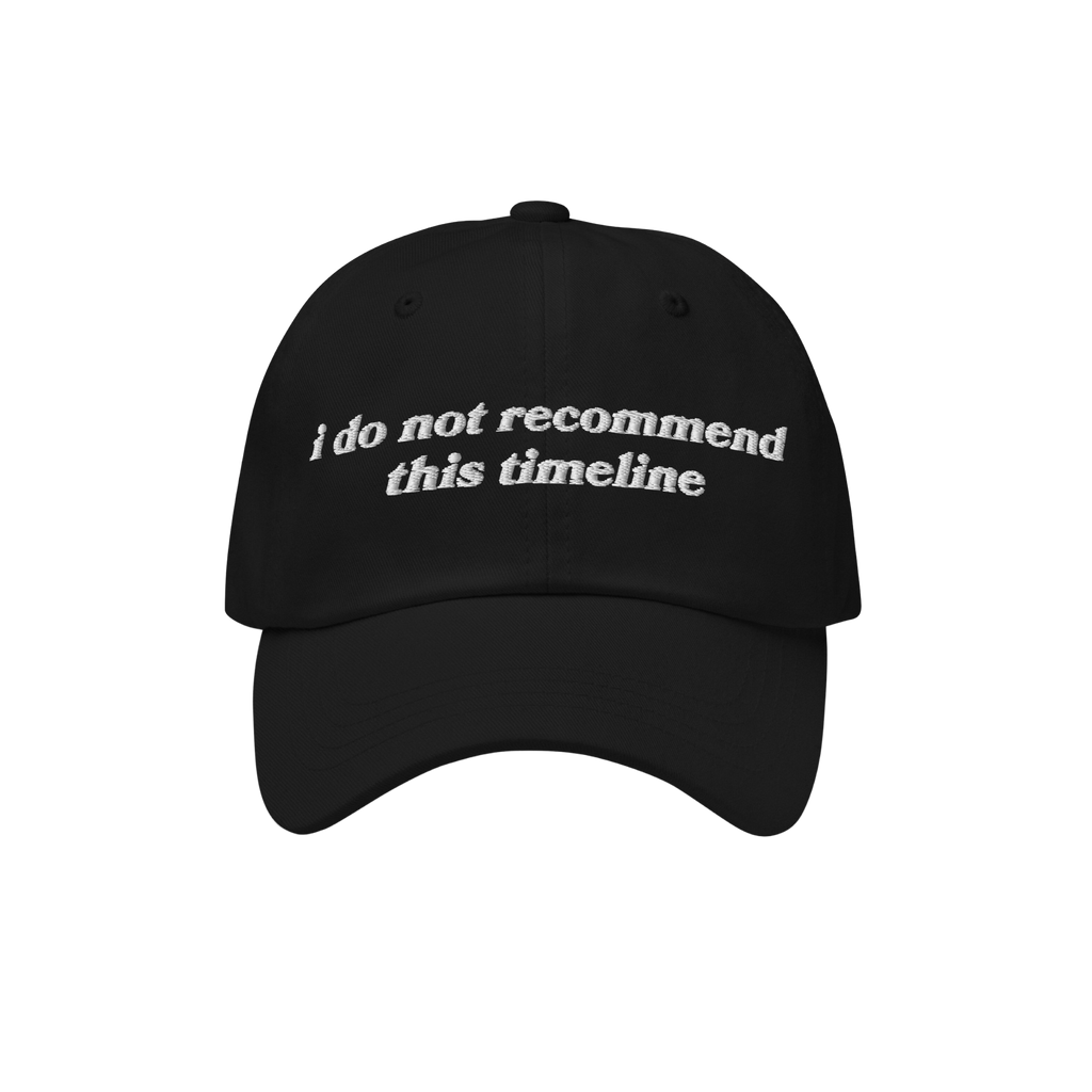 Black baseball-style cap featuring white embroidered text: i do not recommend this timeline. A nod to political humor and ant