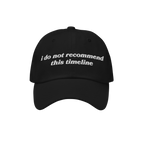 Black baseball-style cap featuring white embroidered text: i do not recommend this timeline. A nod to political humor and ant