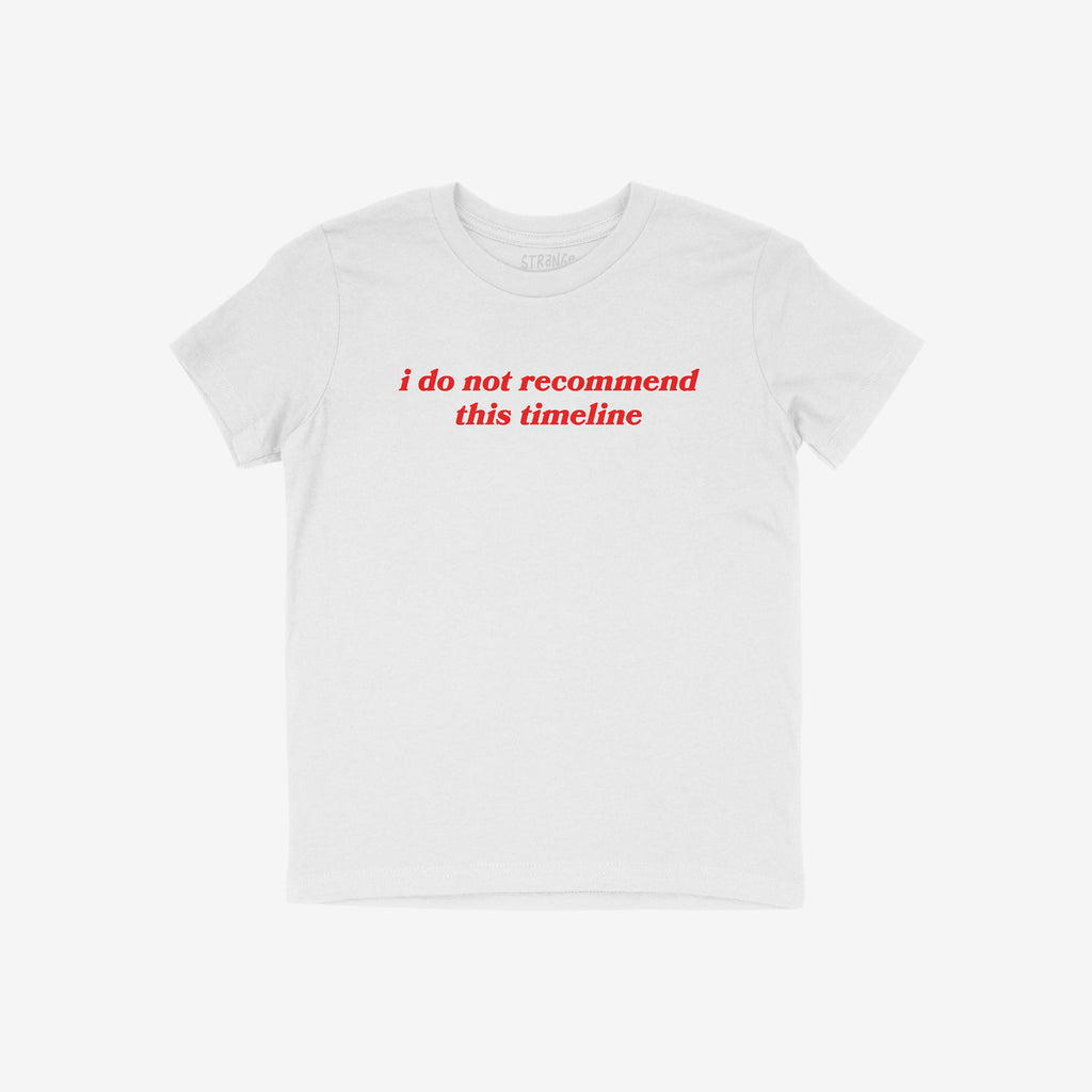 The Timeline Shirt features bold red text stating “i do not recommend this timeline” on a plain white T-shirt, capturing humor and critique, ideal for those embracing sarcasm with style.