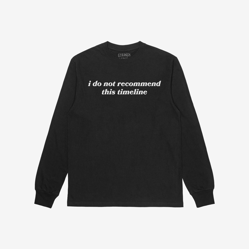 Black long-sleeve Timeline Shirt with ribbed cuffs and crew neckline, featuring “i do not recommend this timeline” text in white. Reflects humor and critique for skeptics and realists.