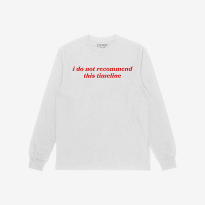 Timeline T-shirt featuring bold red text, i do not recommend this timeline, on a white long-sleeve, reflecting a blend of retro style and social commentary. Brand name visible inside the collar.