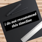 Timeline Sticker & Magnet on a dark desk mat, featuring the phrase “i do not recommend this timeline.” Ideal for expressing existential humor, suited for various surfaces, symbolizing resilience amid chaos.