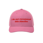 Pink mesh-back trucker hat with red embroidered text i do not recommend this timeline, humorously reflecting political irony.