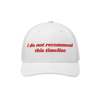 The Timeline Hat features red embroidered text i do not recommend this timeline on a white mesh-back cap, embodying irony and