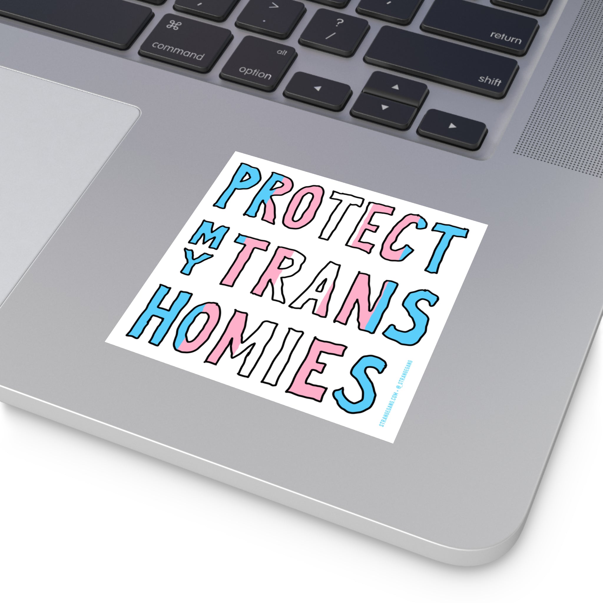 Protect My Trans Homies Sticker & Magnet on a silver laptop corner, showcasing hand-drawn letters in trans pride colors, promoting visibility and advocacy for trans rights with all-weather durability.