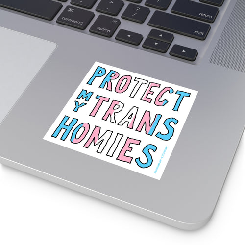 Protect My Trans Homies Sticker & Magnet on a silver laptop corner, showcasing hand-drawn letters in trans pride colors, promoting visibility and advocacy for trans rights with all-weather durability.