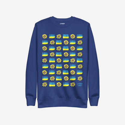 Ukraine Sunflowers Sweatshirt: A royal-blue crewneck featuring a grid of stylized sunflowers and brush-stroke bars, symbolizing unity and resilience, with the designer’s tag in the corner.
