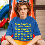 Young person on a red slide wearing the Ukraine Sunflowers Shirt, showcasing a sunflower and flag pattern symbolizing resilience and unity. White-framed sunglasses rest on their head.