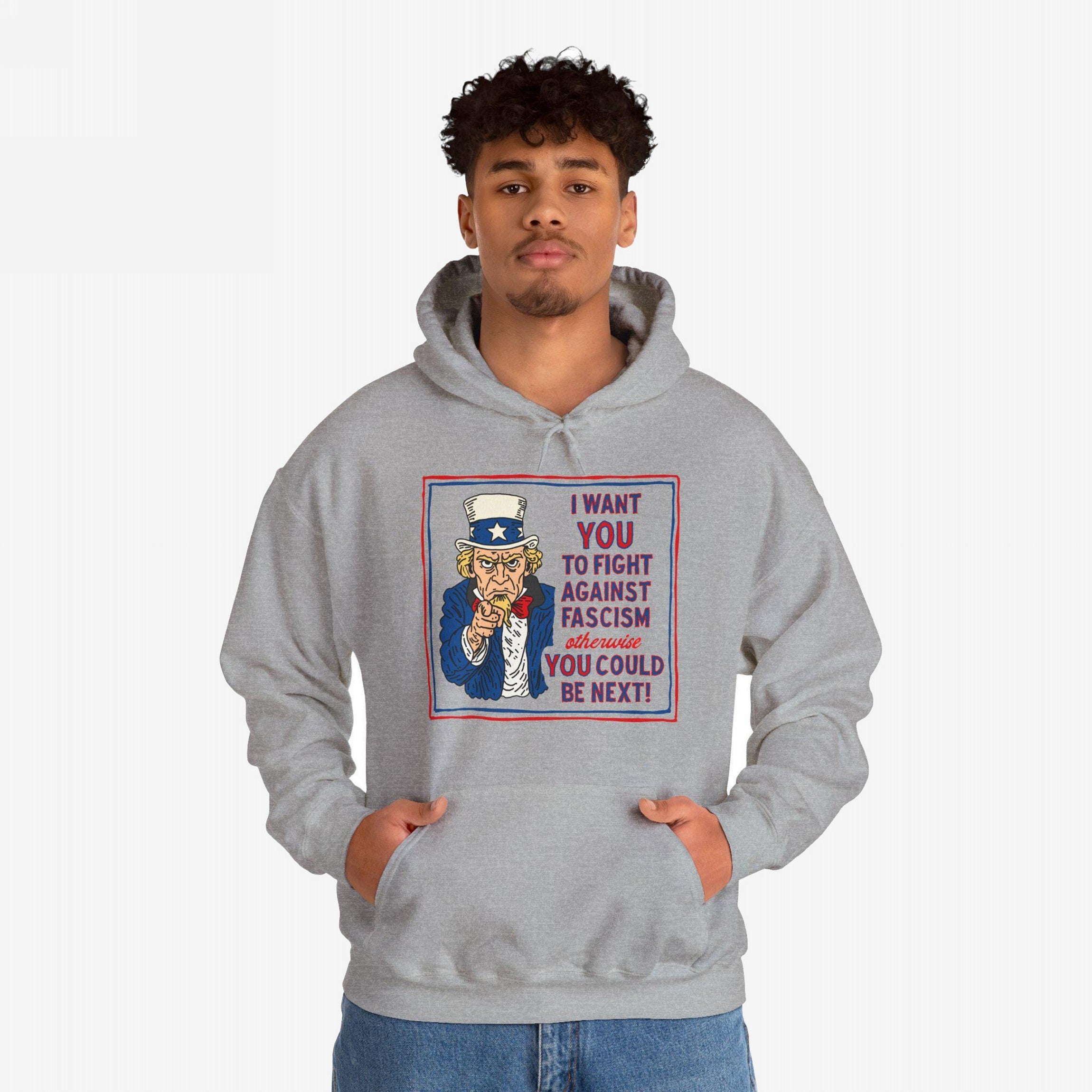 Young man wears the Anti Fascist Uncle Sam Hoodie featuring a bold graphic of Uncle Sam with a message urging resistance against fascism. Ideal for activists supporting equality and justice.