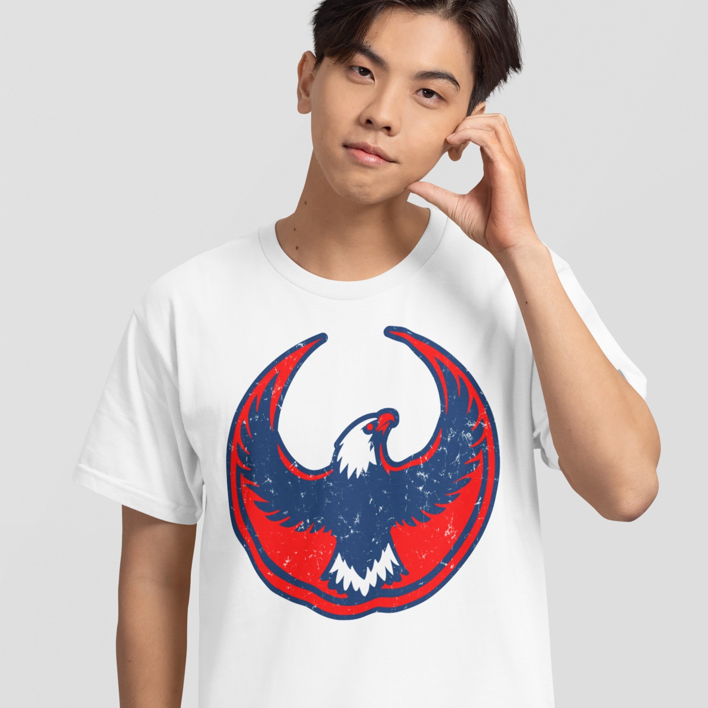 Young man in a USA Rebel Alliance T-shirt featuring a distressed red and blue eagle emblem, embodying anti-fascist themes and patriotism.