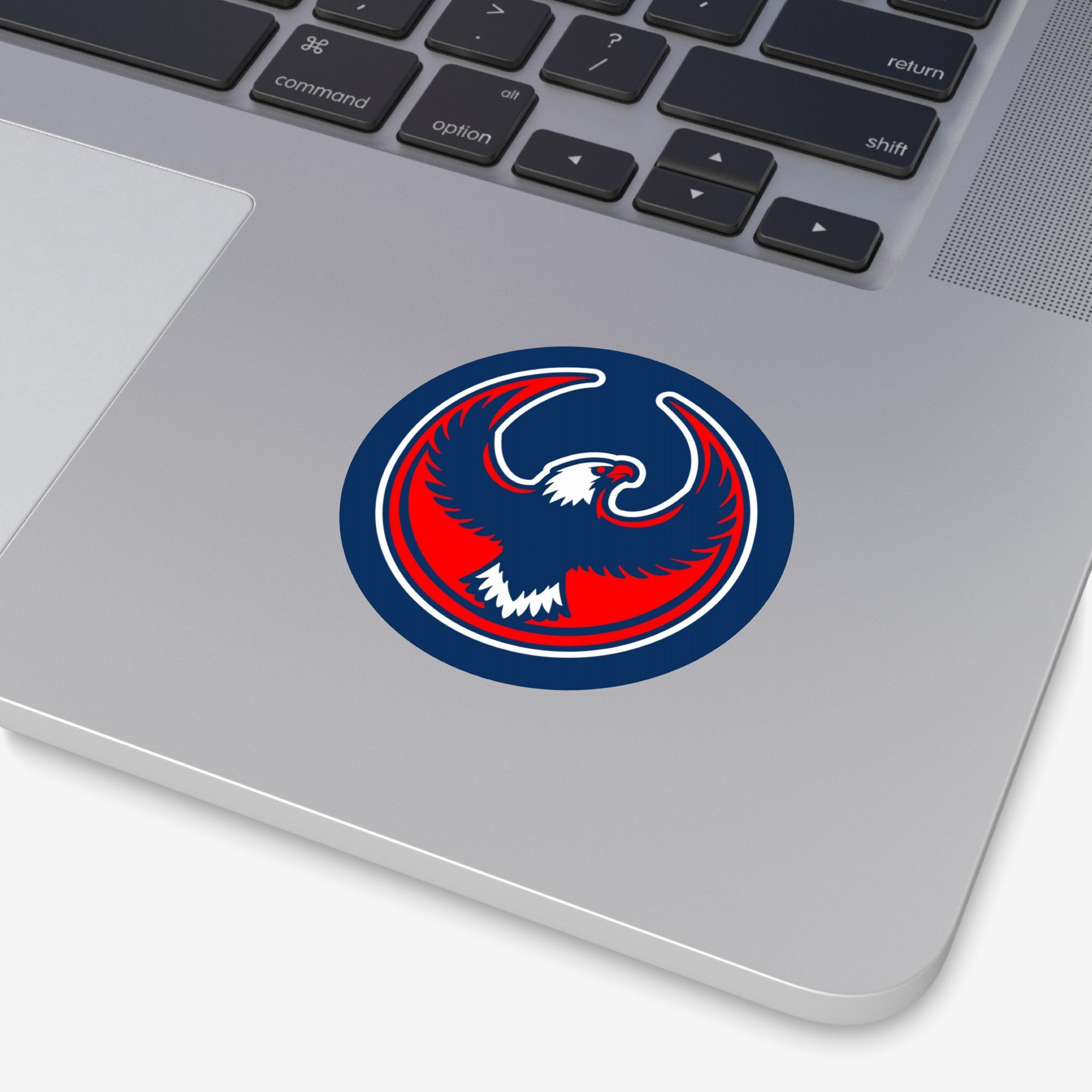 USA Rebel Alliance Sticker on a silver laptop's palm-rest, featuring a stylized eagle emblem in red, white, and blue, symbolizing anti-fascist and pro-immigrant rights sentiments.